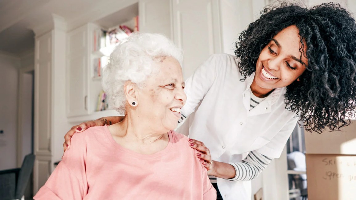 A nurse checking in when an older female patient.