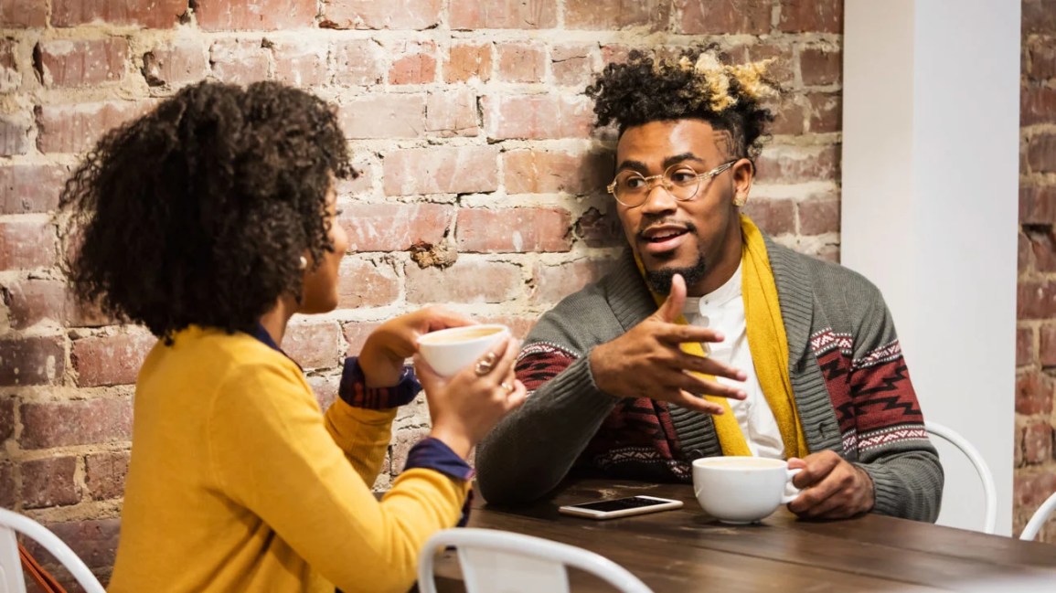 couple having a conversation over coffee in a cafe