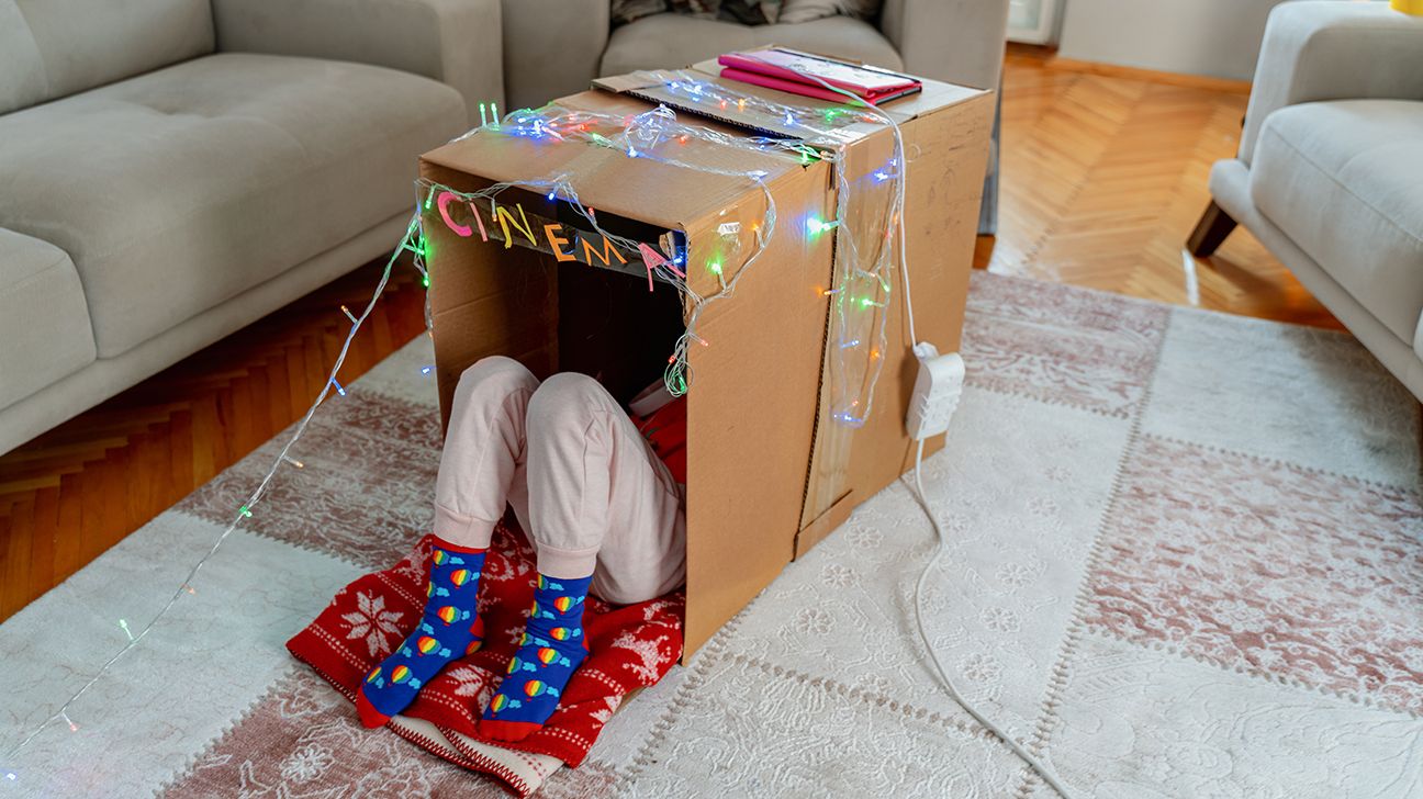 child with ADHD playing in a box they decorated-1