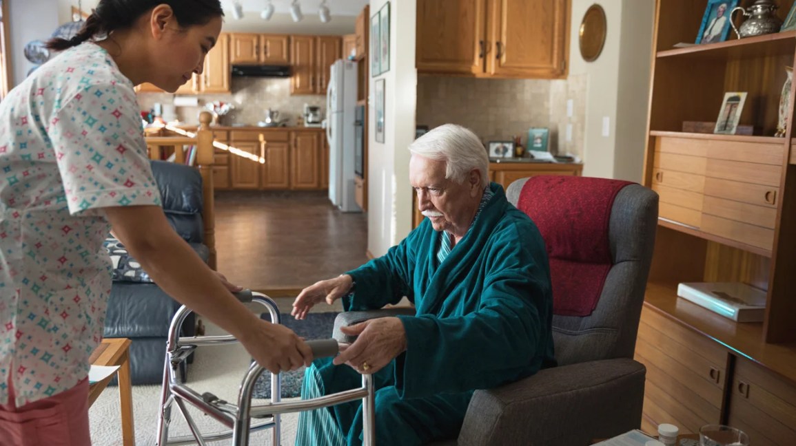 home health aide helping older adult with dementia-1