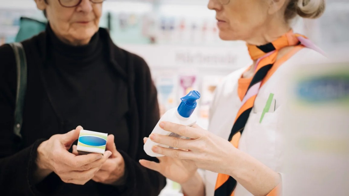 A female pharmacist advising and older female patient on medications.