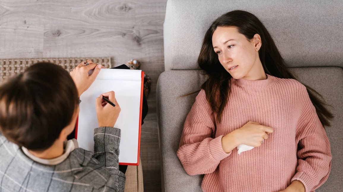 woman lying down talking to a therapist